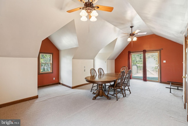 dining space with ceiling fan, plenty of natural light, vaulted ceiling, and carpet floors