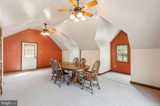 dining area with baseboards, a ceiling fan, lofted ceiling, and carpet