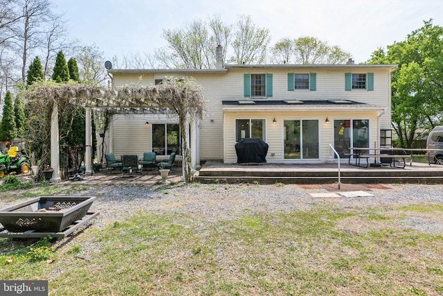 rear view of property with a deck, a pergola, and outdoor lounge area