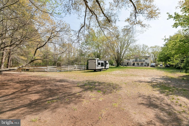 view of yard with fence and an outdoor structure