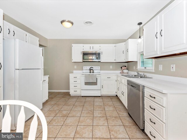 kitchen featuring a sink, appliances with stainless steel finishes, white cabinets, and light countertops