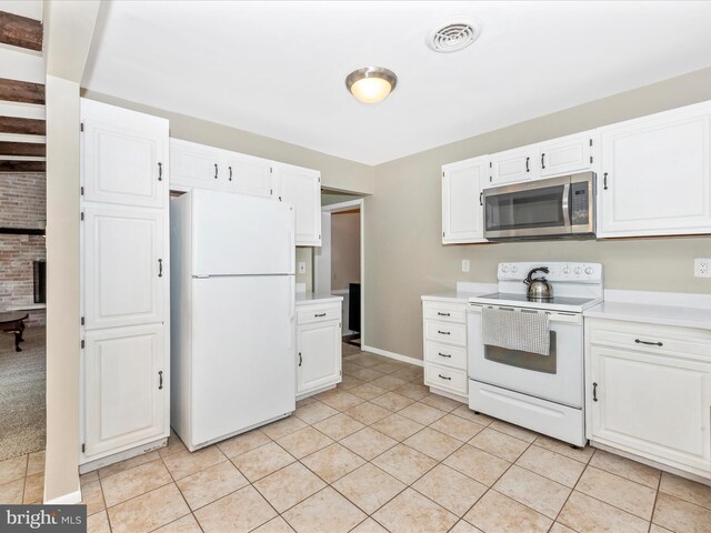 kitchen with white appliances, white cabinetry, visible vents, and light countertops