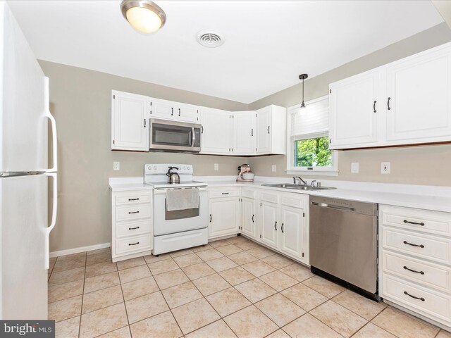 kitchen featuring light countertops, stainless steel appliances, visible vents, and a sink