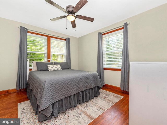 bedroom featuring baseboards, ceiling fan, and hardwood / wood-style flooring
