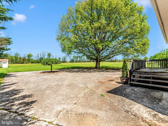 view of patio featuring an outdoor structure and a deck