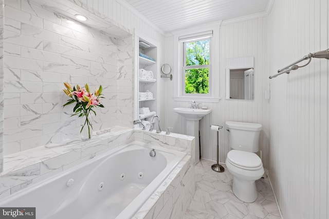 full bathroom with crown molding, a whirlpool tub, toilet, and a sink