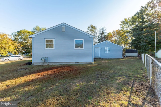 20 Coville Dr, Browns Mills, NJ 08015 - back of house featuring an outdoor structure, fence, crawl space, a shed, and a lawn