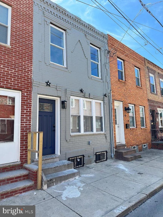 view of front facade featuring brick siding and entry steps