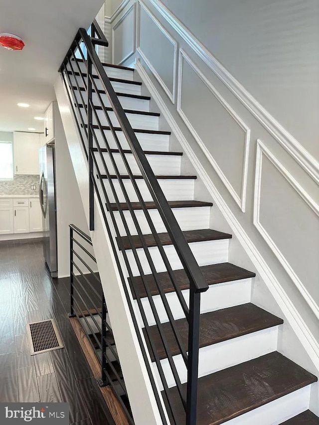stairway featuring recessed lighting