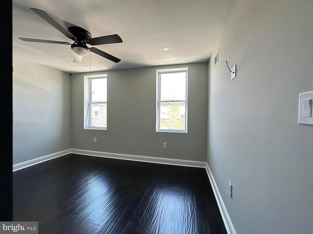 spare room with a healthy amount of sunlight, baseboards, ceiling fan, and visible vents