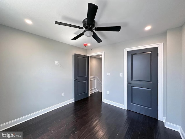 spare room featuring baseboards, ceiling fan, recessed lighting, and dark wood-type flooring