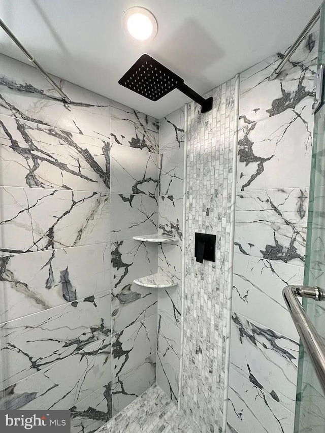 full bathroom with a marble finish shower