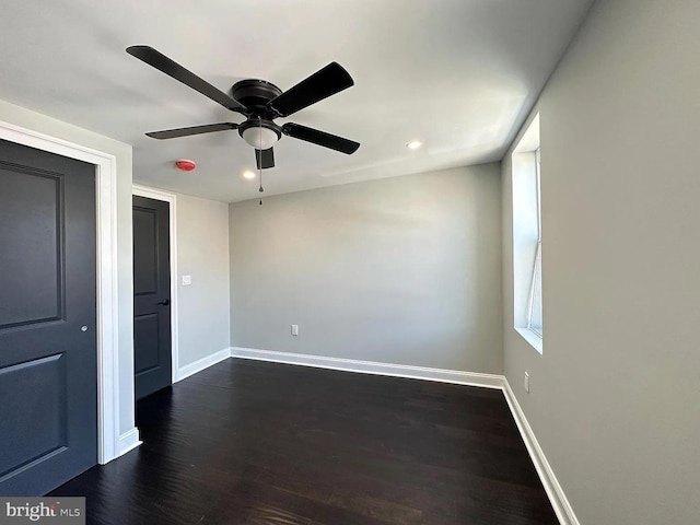 unfurnished bedroom featuring baseboards, recessed lighting, dark wood-type flooring, and a ceiling fan