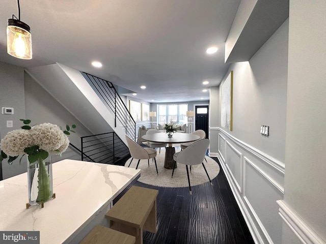 dining space featuring recessed lighting, wainscoting, stairs, and dark wood-type flooring