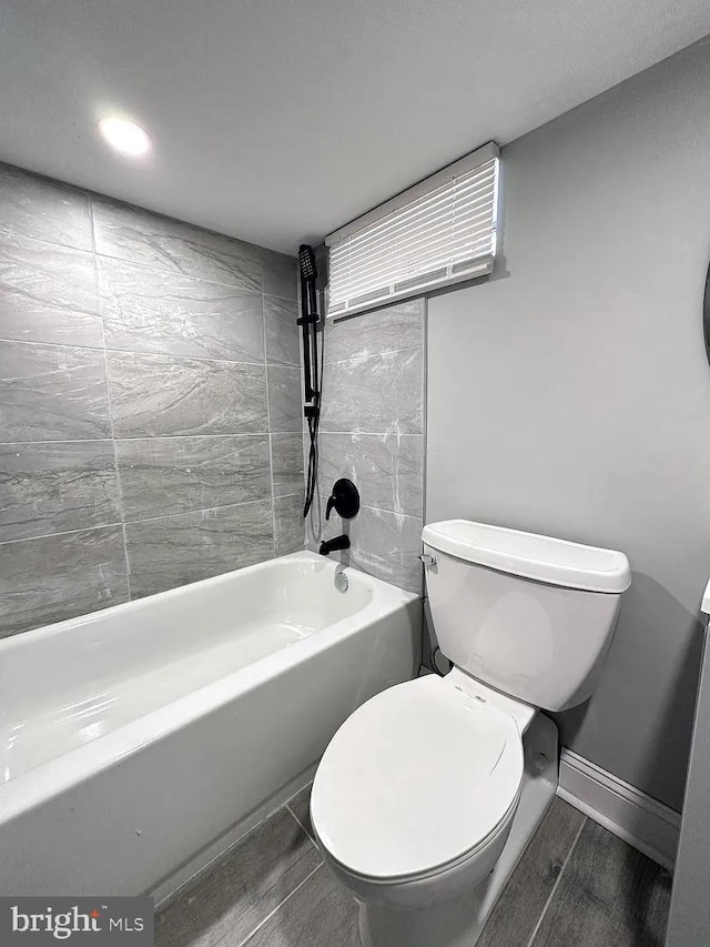 bathroom featuring baseboards and toilet