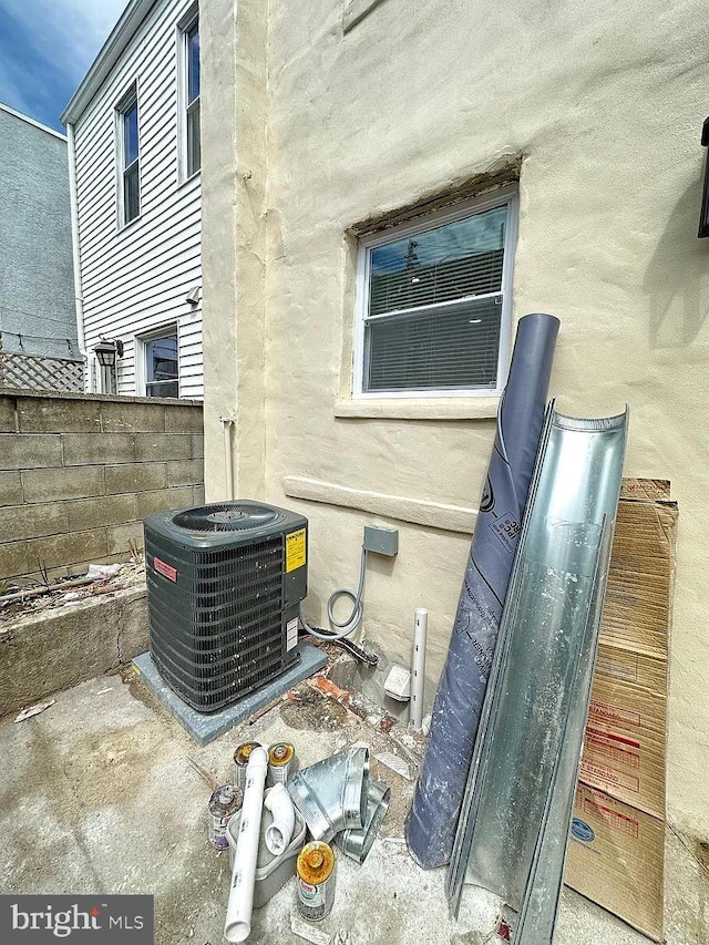 exterior details featuring central air condition unit and fence