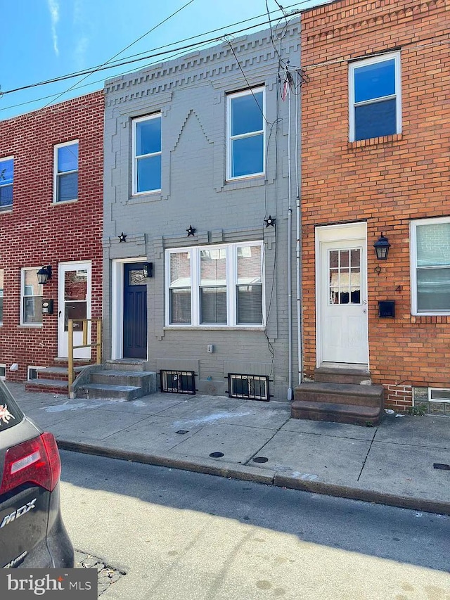 multi unit property with brick siding and entry steps