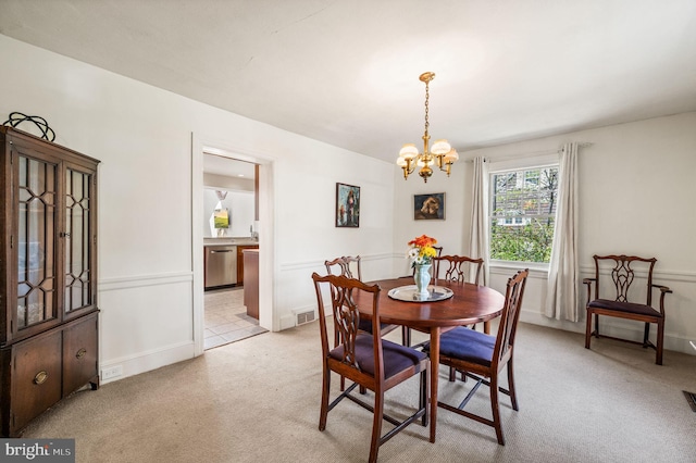 dining room featuring an inviting chandelier, baseboards, light carpet, and visible vents