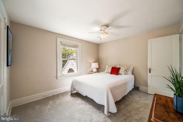carpeted bedroom with a ceiling fan and baseboards
