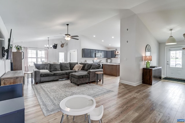 147 Langley Dr, Waynesboro, VA 22980 - living area featuring a healthy amount of sunlight, high vaulted ceiling, ceiling fan with notable chandelier, and light wood-style flooring