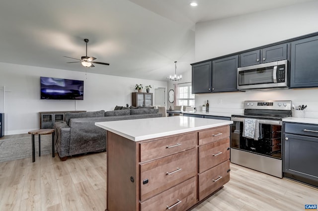 147 Langley Dr, Waynesboro, VA 22980 - kitchen with appliances with stainless steel finishes, light wood-style floors, light countertops, ceiling fan with notable chandelier, and a center island