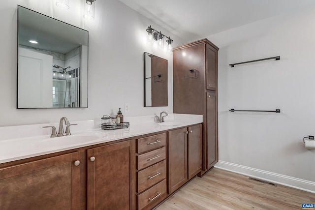 147 Langley Dr, Waynesboro, VA 22980 - bathroom with double vanity, visible vents, wood finished floors, a sink, and baseboards