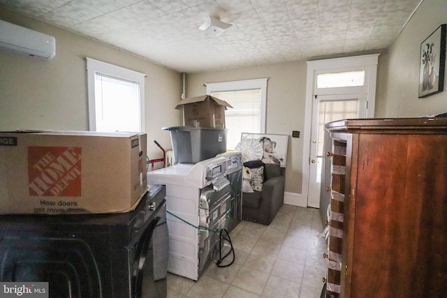 interior space with light tile patterned flooring and a wall mounted AC