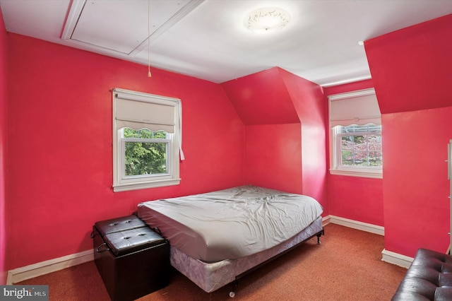 bedroom with attic access, vaulted ceiling, carpet, and baseboards