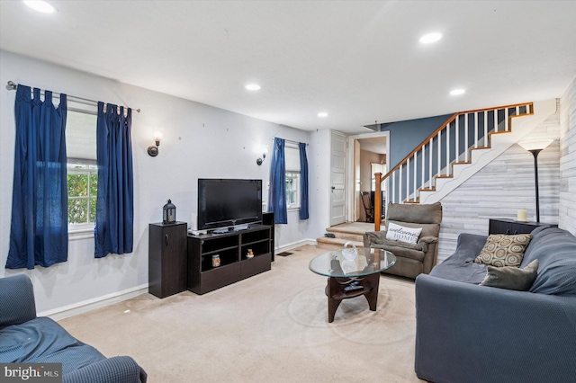 carpeted living area with baseboards, recessed lighting, and stairway