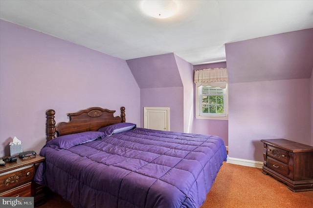 bedroom featuring baseboards, carpet floors, and vaulted ceiling