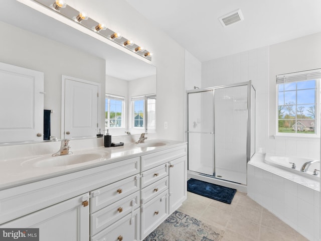 1022 Fawn Haven Walk, Dover, DE 19901 - bathroom with visible vents, tile patterned flooring, double vanity, a shower stall, and a sink