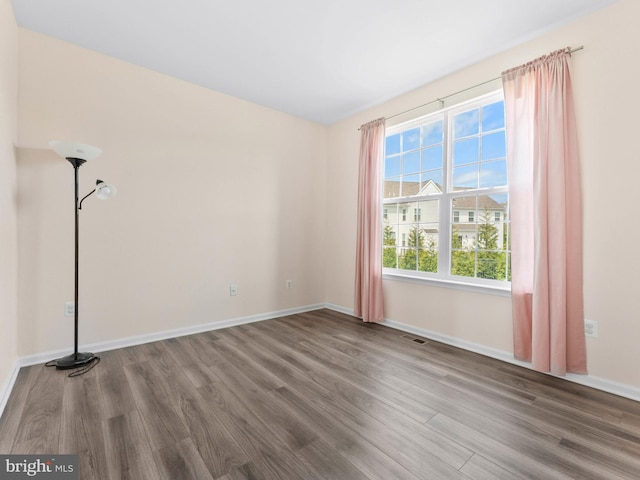 1022 Fawn Haven Walk, Dover, DE 19901 - spare room with baseboards, visible vents, and wood finished floors