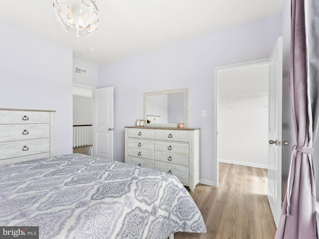 1022 Fawn Haven Walk, Dover, DE 19901 - bedroom featuring visible vents, wood finished floors, a spacious closet, and a closet