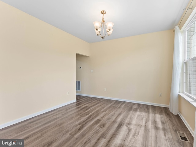 1022 Fawn Haven Walk, Dover, DE 19901 - unfurnished room with visible vents, wood finished floors, and a chandelier