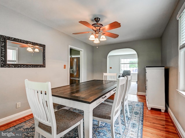 7612 Daniels Ave, Baltimore, MD 21234 - dining space with arched walkways, light wood-style floors, ceiling fan, and baseboards