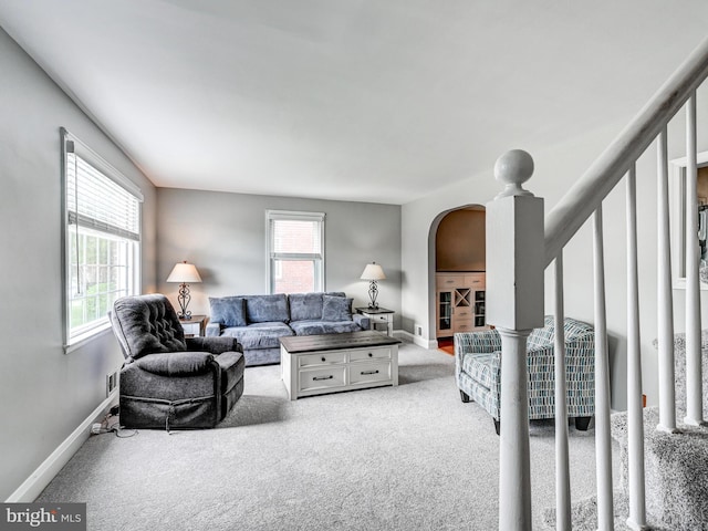 7612 Daniels Ave, Baltimore, MD 21234 - living room with arched walkways, plenty of natural light, carpet floors, and baseboards