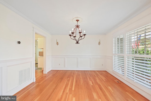 9373 Robnel Pl, Vienna, VA 22182 - unfurnished dining area featuring an inviting chandelier, crown molding, a decorative wall, and visible vents