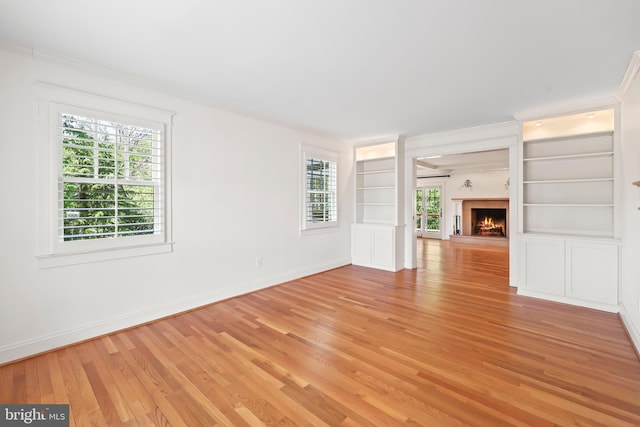 9373 Robnel Pl, Vienna, VA 22182 - empty room featuring crown molding, built in features, baseboards, and light wood-style floors