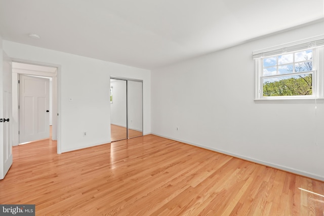 9373 Robnel Pl, Vienna, VA 22182 - unfurnished bedroom with baseboards, light wood-style flooring, and a closet