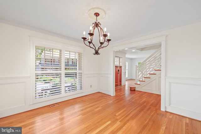 9373 Robnel Pl, Vienna, VA 22182 - unfurnished dining area featuring visible vents, stairs, a decorative wall, plenty of natural light, and a chandelier