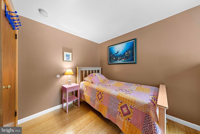 bedroom featuring baseboards and wood finished floors