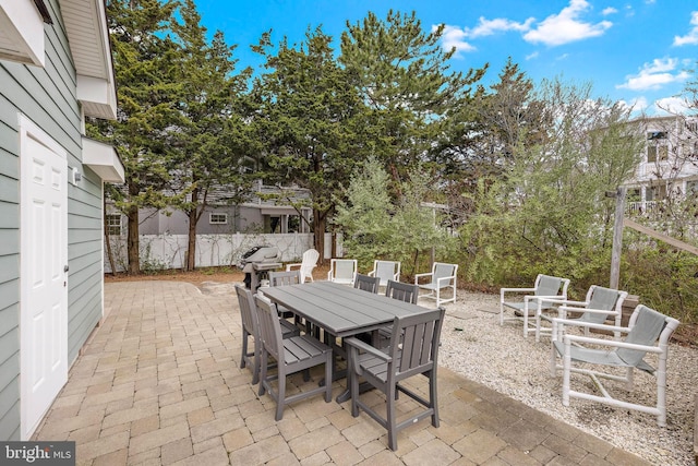 view of patio / terrace featuring fence and outdoor dining space