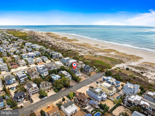 birds eye view of property with a water view, a residential view, and a view of the beach
