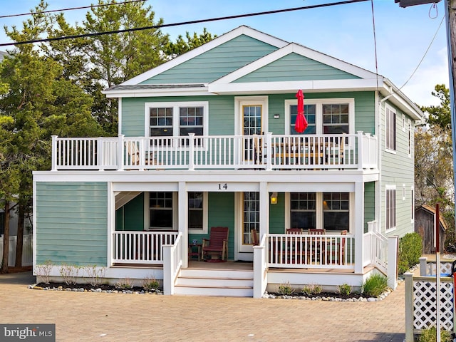 view of front of house with covered porch and a balcony