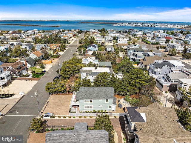 birds eye view of property featuring a water view and a residential view