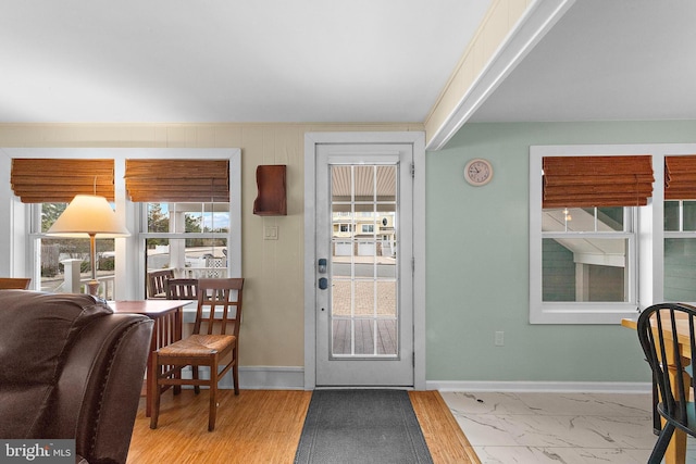 doorway featuring baseboards and marble finish floor
