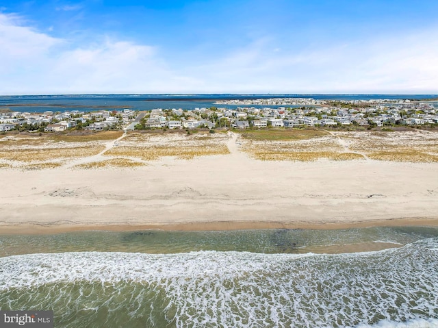 bird's eye view featuring a water view and a view of the beach