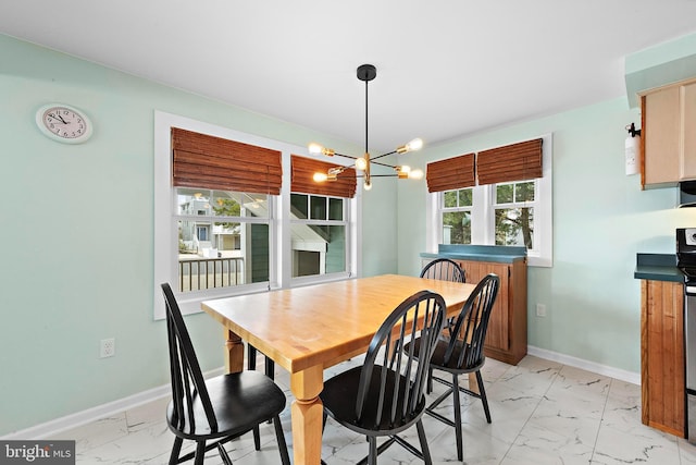 dining room featuring baseboards, marble finish floor, and a chandelier