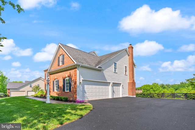 view of property exterior with an attached garage, a chimney, brick siding, driveway, and roof with shingles