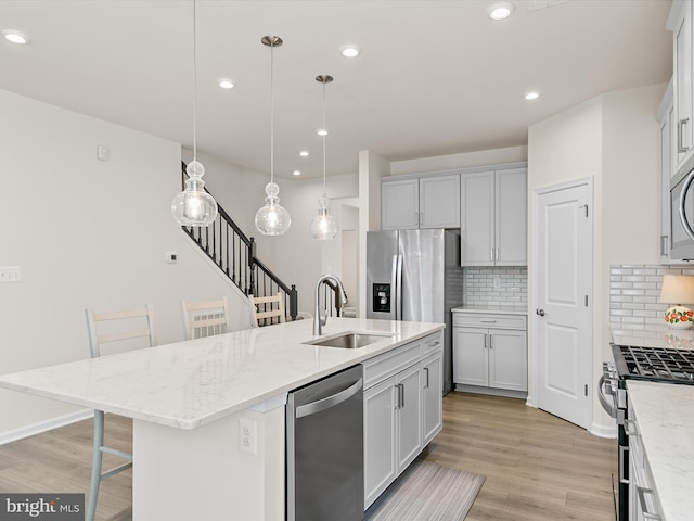 37268 Brenda Ln, Frankford, DE 19945 - kitchen featuring a sink, decorative backsplash, appliances with stainless steel finishes, and a center island with sink